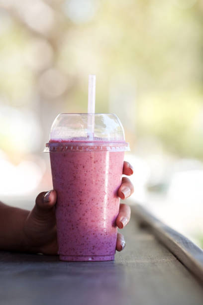 istock female hand holding smoothie drink 920743480