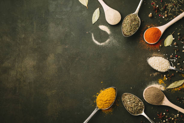 istock Spices and herbs over black stone background. Top view. Copy space 920746684