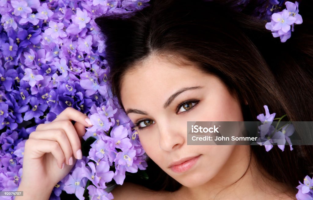 Beauty Beautiful woman laying in a bed of flowers Exoticism Stock Photo