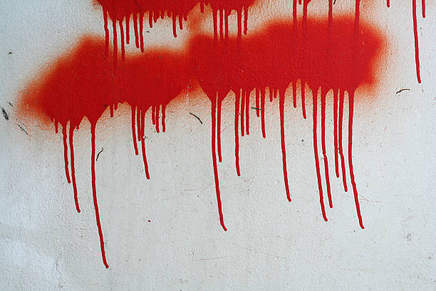 Absctract red coloured wall background. Close-up view of red painted textured concrete wall with white streaks. Copy space for your text or decorations. Colorful construction material background theme