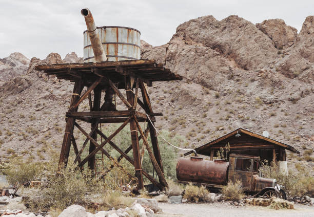 istock Old vintage rusty car truck abandoned in the desert 920749672