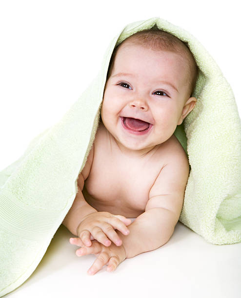 istock Happy baby underneath towel laying on flat surface 92075952