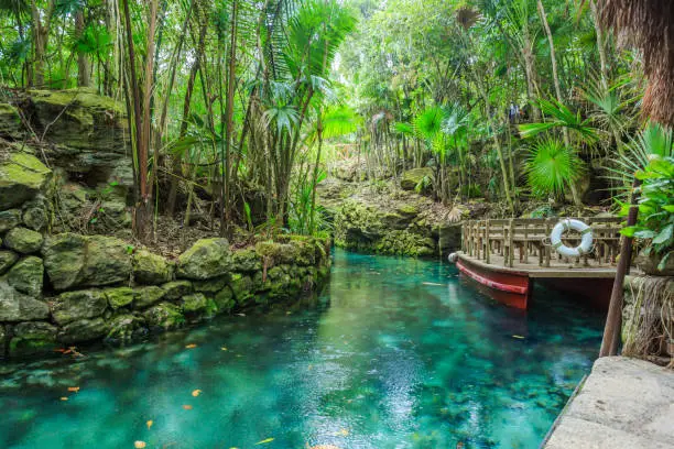 Small river arounded with the rocks in park Xcaret, Mexico
