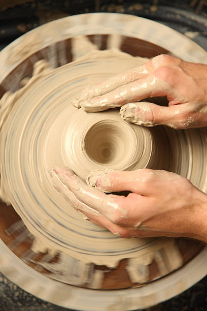 istock Overhead view of hands shaping pottery 92077409