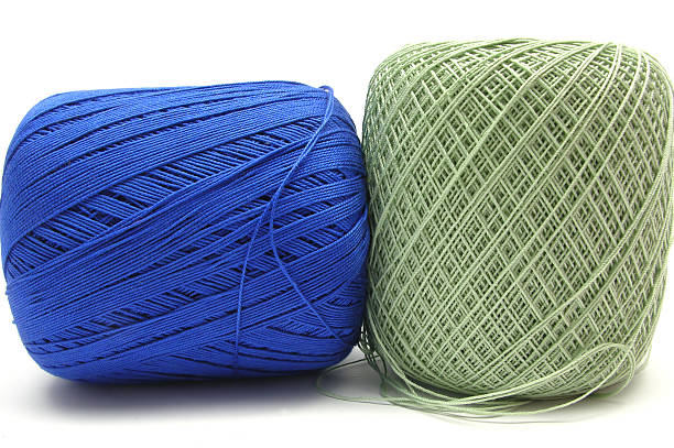 istock Two balls of wool in blue and green on white 92077712