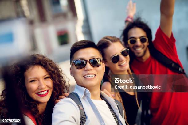 Multiracial Couples Exploring A City Happy Tourists Discovering New Locations Making Selfie Stock Photo - Download Image Now