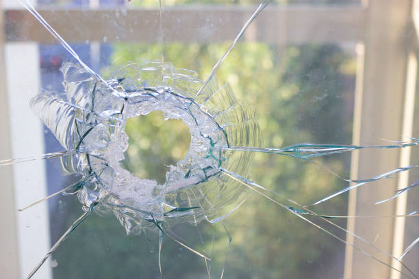 istock broken glass window reflecting blue sky 920787288