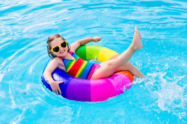 istock Child with toy ring in swimming pool 920793782