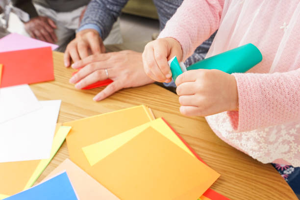 istock Child folding origami paper 920820818