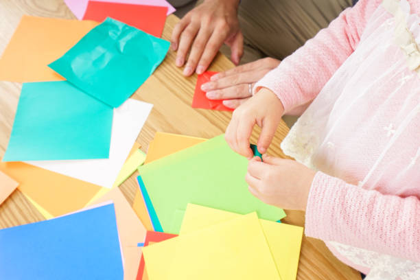 istock Child folding origami paper 920820832