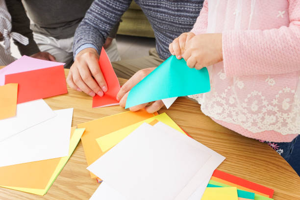 istock Child folding origami paper 920820834