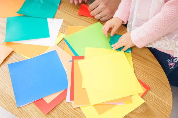 istock Child folding origami paper 920820840