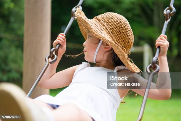 Little Girl Playing With A Swing Stock Photo - Download Image Now - Public Park, Child, Summer