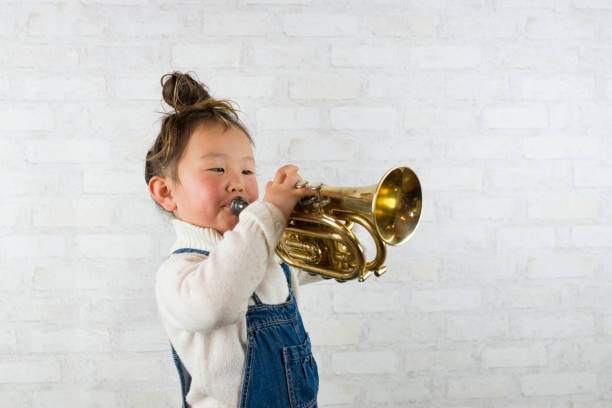 istock Little girl playing the trumpet 920831122