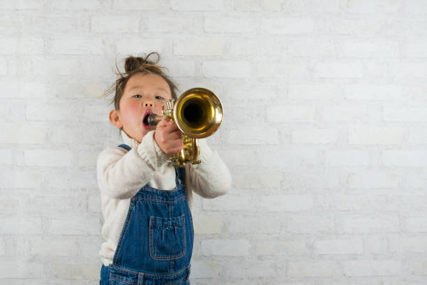 istock Little girl playing the trumpet 920831132