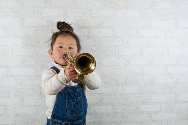 istock Little girl playing the trumpet 920831164