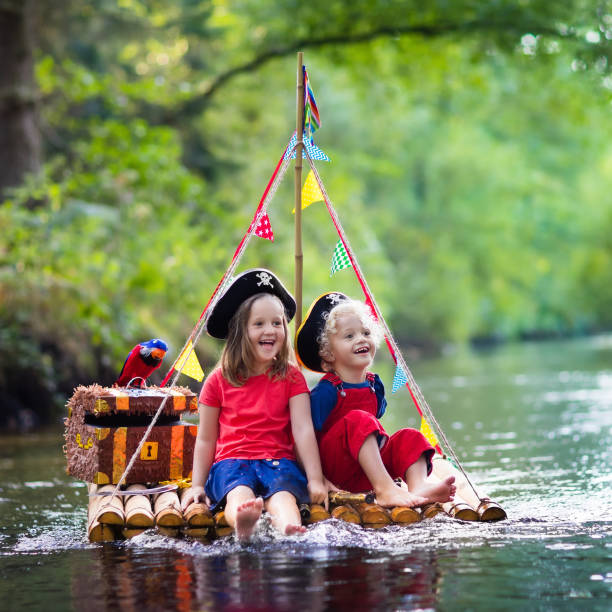 istock Kids playing pirate adventure on wooden raft 920831254
