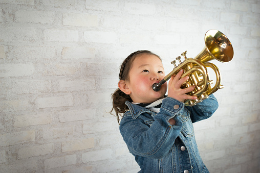 Little girl playing the trumpet