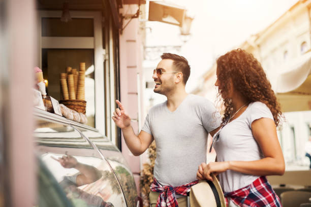 istock Young couple buying ice cream, smiling choosing right one. 920835726