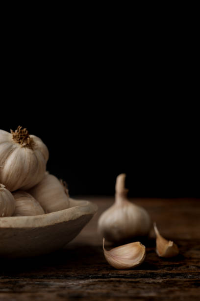 istock Still life of garlic bulb in dark black background 920852146