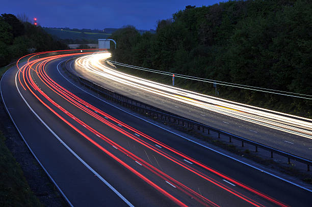 istock Streams of car lights at night on the interstate  92085353