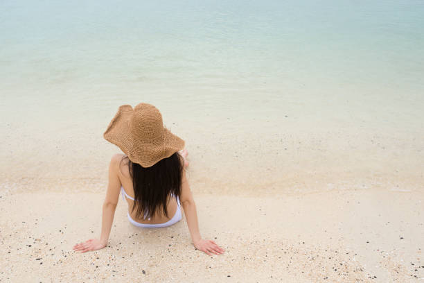 istock Woman relaxing on the beach 920862670