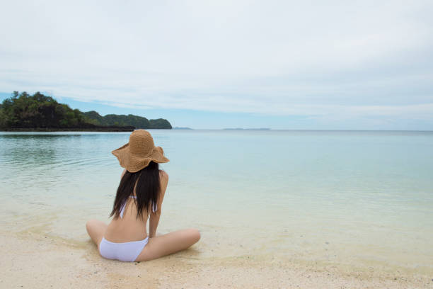 istock Woman relaxing on the beach 920862674
