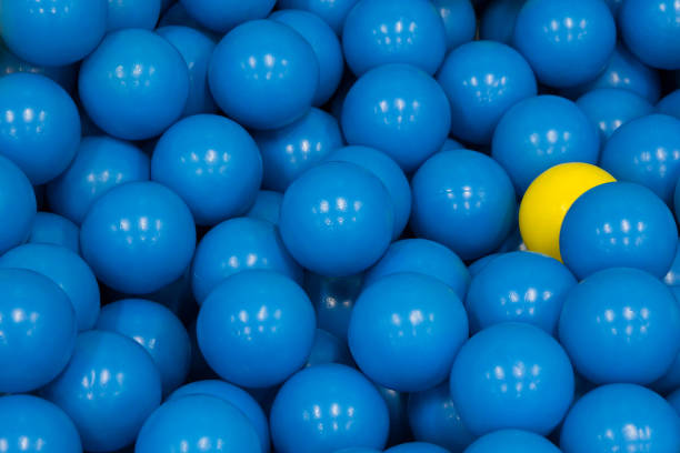 istock plastic balls, yellow plastic ball among blue plastic ball, concept : different, hiding power, fear, beware, spy 920862804