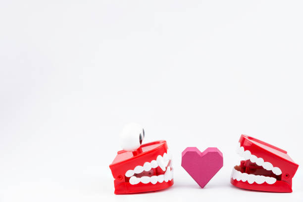 istock Red Plastic Wind Up Chattering Teeth biting paper box red heart shape at Valentine's Day.Concept Valentine's Day, Day of love. 920865680