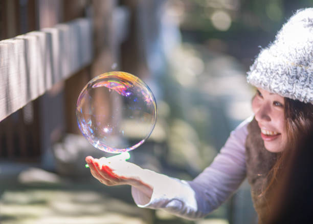 A stream of clear, transparent bubbles rises through a liquid medium. This dynamic visual creates an abstract and energetic effect, suitable for various design projects.