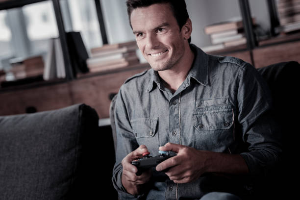 istock Excited mature gentleman playing video games 920882482