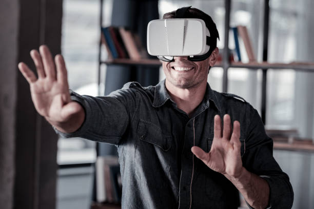 istock Smiling adult man wearing virtual reality goggles 920882714