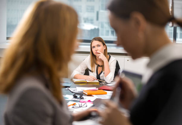 girl overhears the conversation of her colleagues Office life. The girl overhears the conversation of her colleagues at work in the office eavesdropping stock pictures, royalty-free photos & images