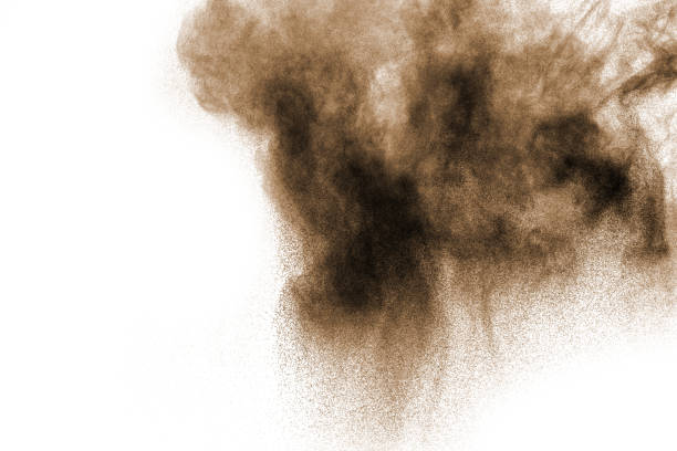 istock coco color particles splatter on white background. Deep brown dust splash on white background. 920902548