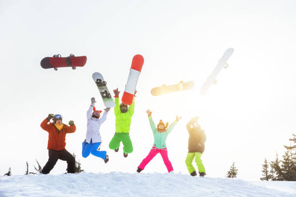 istock Five happy friends snowboarders jumps and having fun 920905678