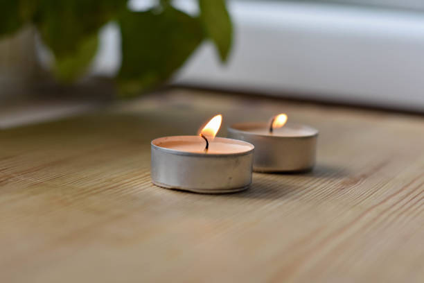 istock little candle cup light up on the wooden table 920905862