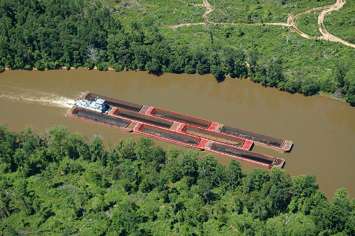 barge floats on the channel, water logistics, cargo transportation.