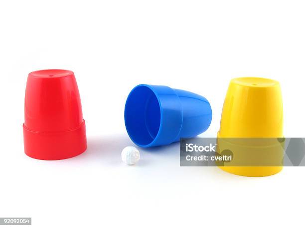 Three Cups Magic Trick Isolated On A White Background Stock Photo - Download Image Now