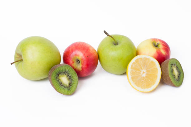 istock Fruits in a composition on a white background. Lemon with apples and kiwi on white background. Fruits with carrots on a white background. 920924088