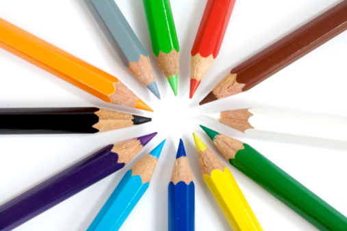 Seven coloured crayon on white background