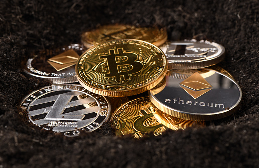 İstanbul, Turkey - January 28, 2018: Close up shot of Bitcoin, Litecoin and Ethereum memorial coins on soil. Bitcoin, Litecoin and Ethereum  is a crypto currency and a worldwide payment system.