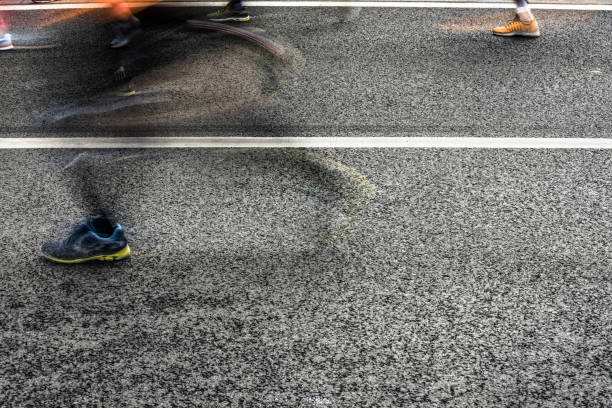 istock People running in marathon on city streets. Motion blur. 920931882