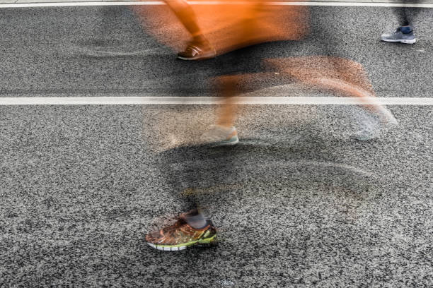 People running in marathon on city streets. Motion blur.