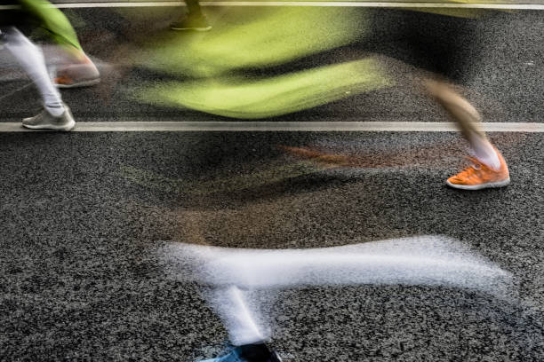 istock People running in marathon on city streets. Motion blur. 920931892