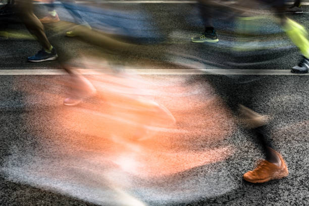 People running in marathon on city streets. Motion blur.