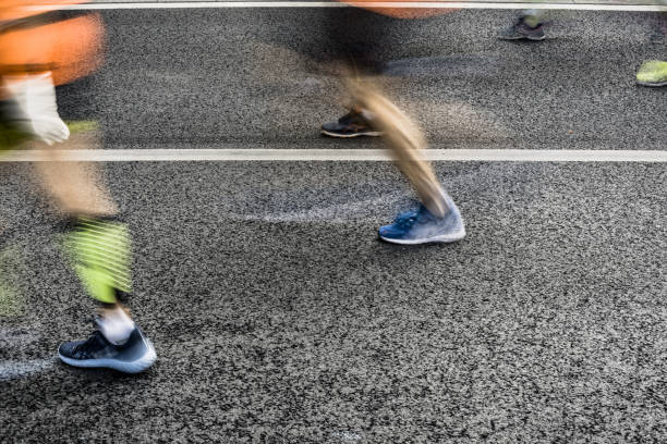 istock People running in marathon on city streets. Motion blur. 920931900