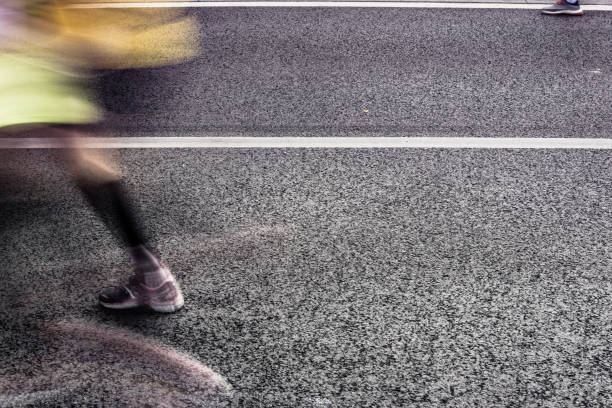 istock People running in marathon on city streets. Motion blur. 920931906