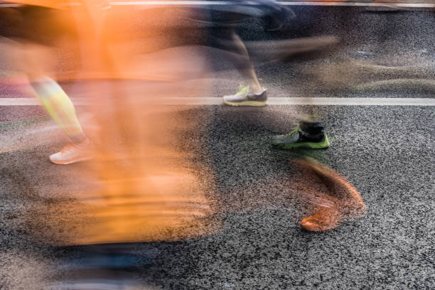 istock People running in marathon on city streets. Motion blur. 920931908