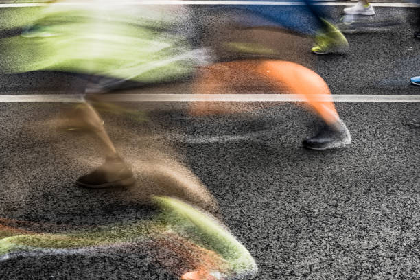 istock People running in marathon on city streets. Motion blur. 920931916
