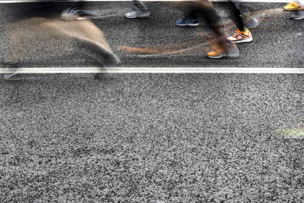 istock People running in marathon on city streets. Motion blur. 920931928